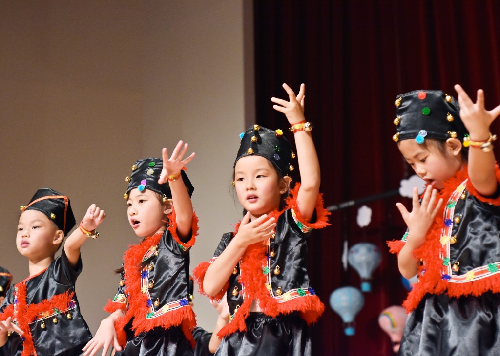 Clad in traditional costumes with bells on their wrists, children dancing to celebrate the courageousness of a Taiwanese tribal community.